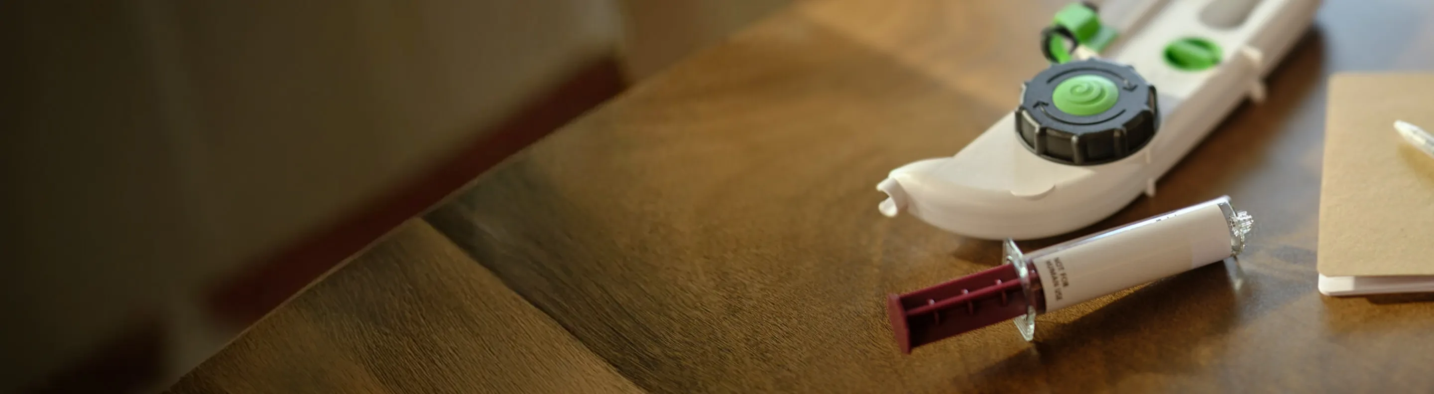 Close-up of a Hizentra prefilled syringe on a table, used for subcutaneous Ig dosing